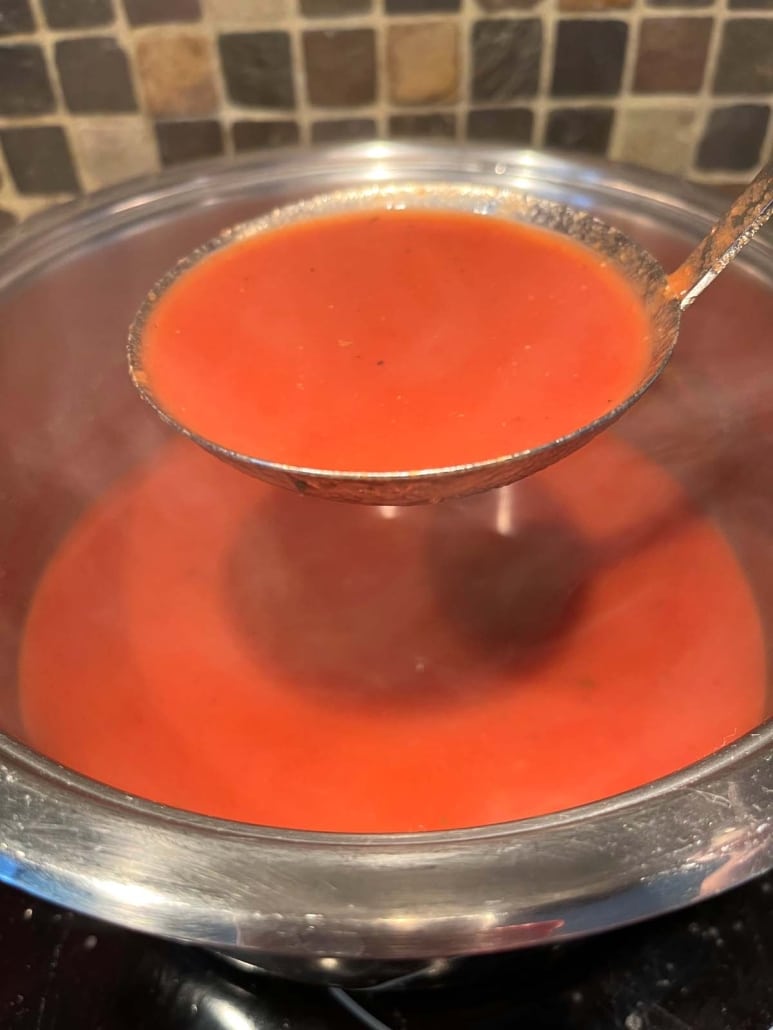 ladling out portions of Tomato Soup With Tomato Paste