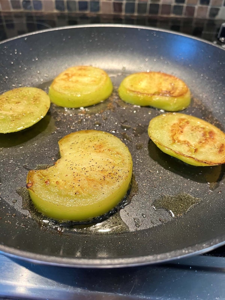 Fried Green Tomatoes (without breading) cooking on a skillet