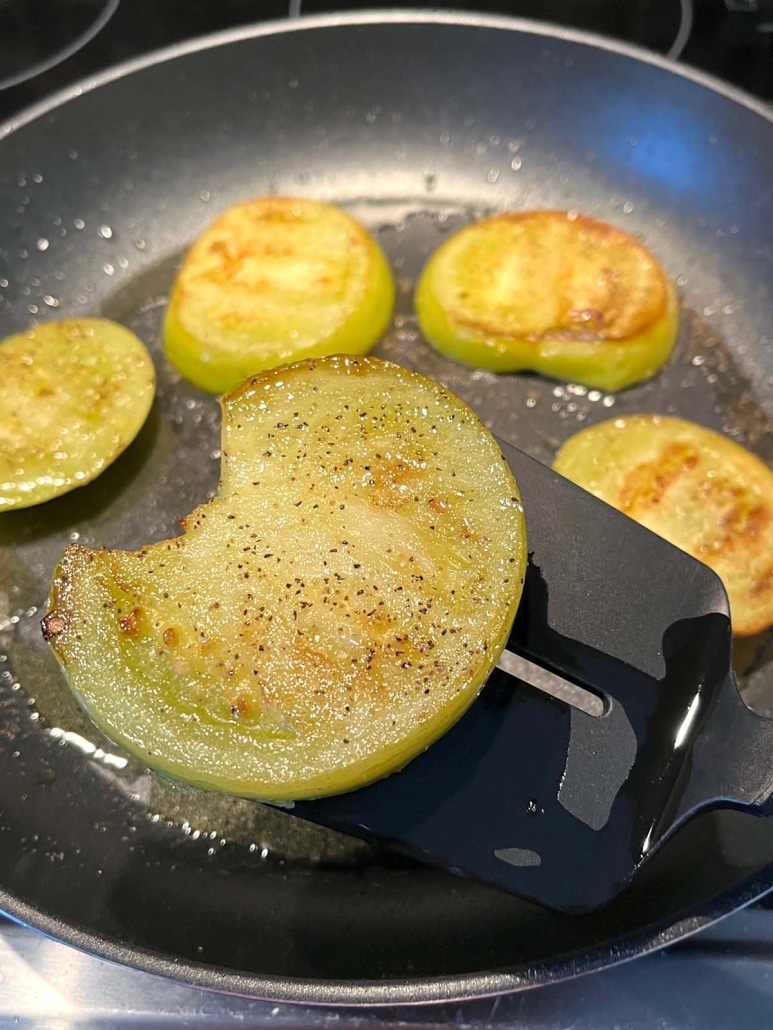 Fried Green Tomato slice on a spatula