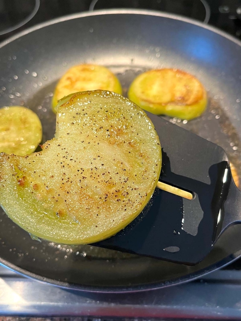 spatula scooping up a low carb Fried Green Tomatoes No Breading