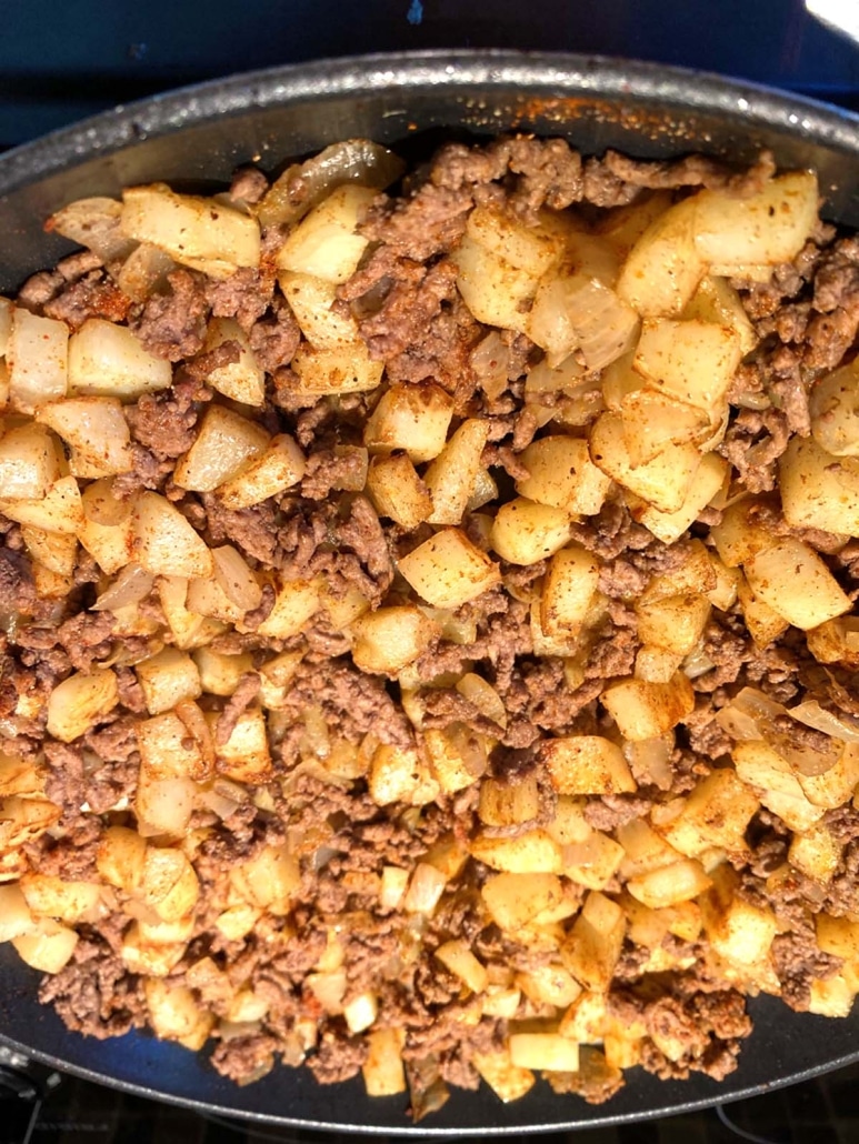 flavorful Ground Beef And Potatoes cooking in a pan