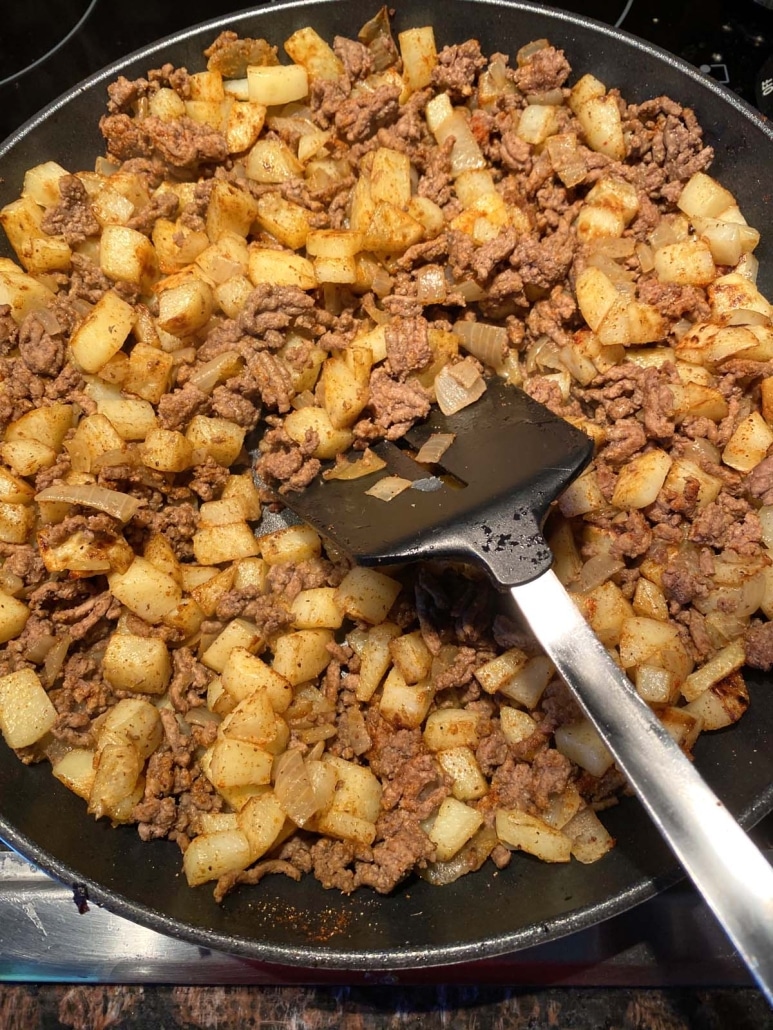 spatula stirring up Ground Beef And Potatoes as it cooks