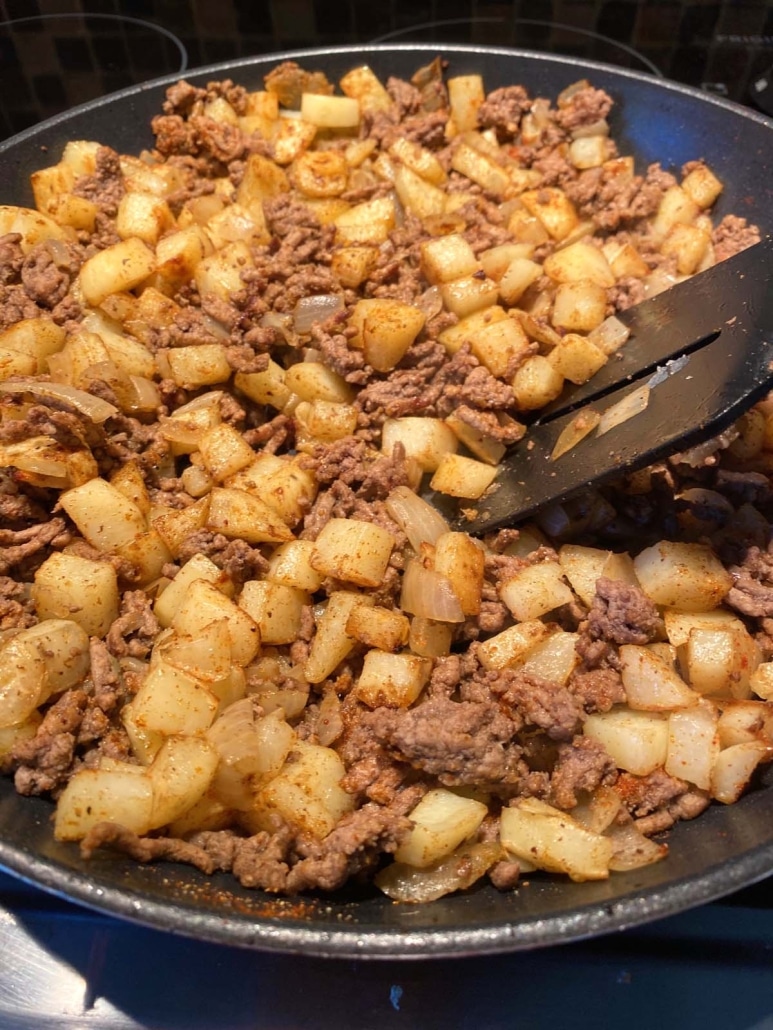 spatula stirring up Ground Beef And Potatoes meal