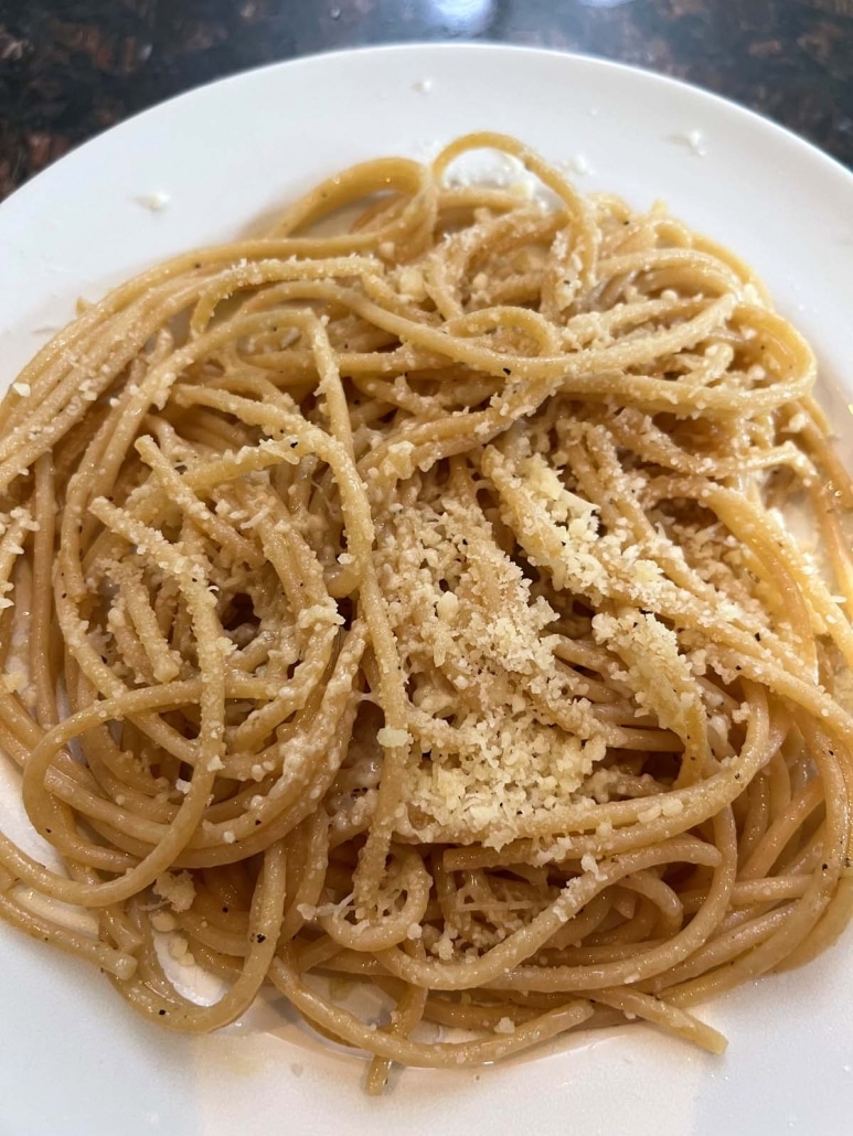 grated parmesan cheese sprinkled on Whole Wheat Spaghetti With Garlic And Olive Oil