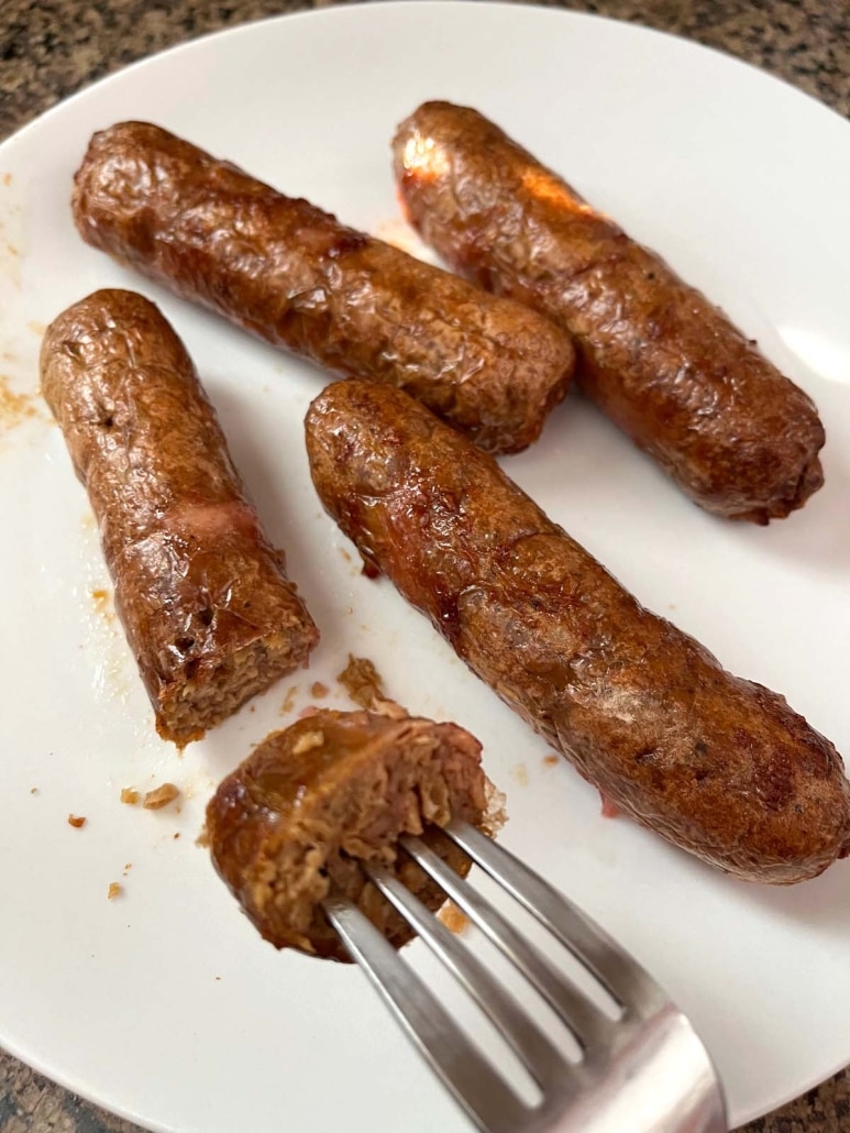 fork holding a bite of Air Fryer Beyond Sausage