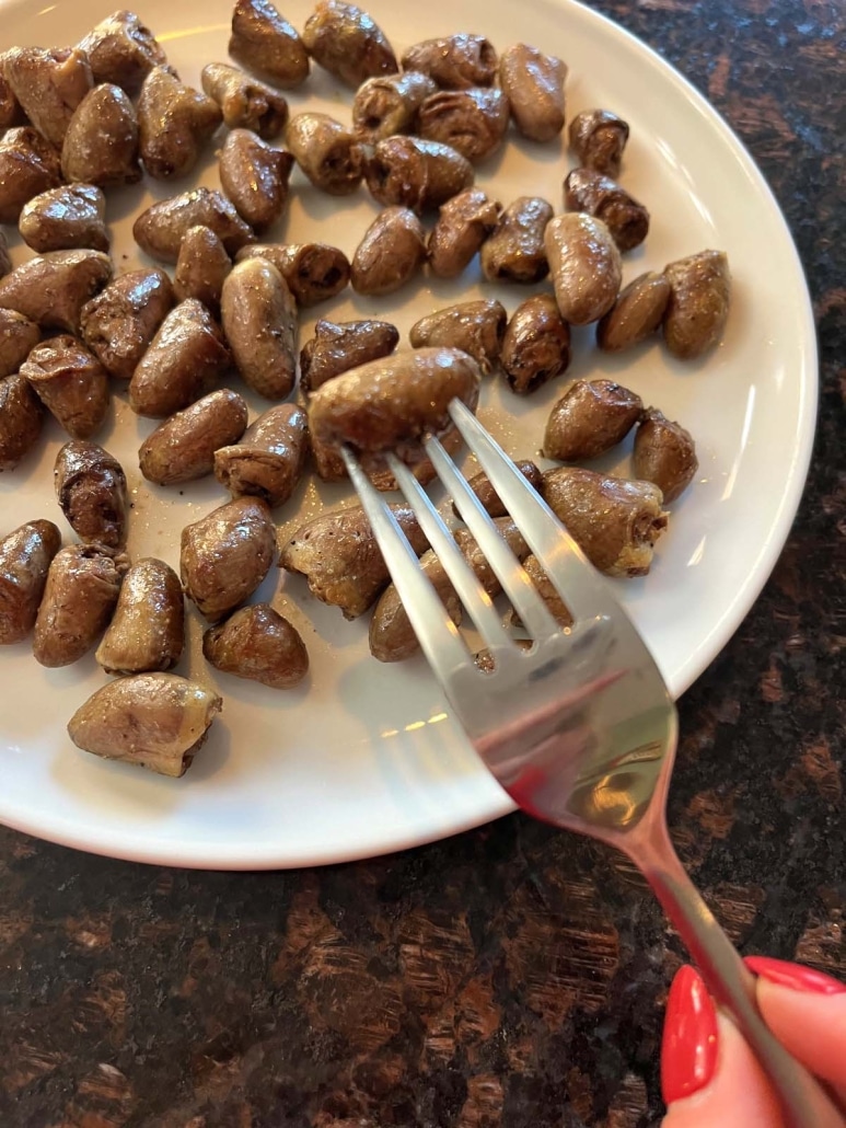 fork holding a tender, cooked chicken heart