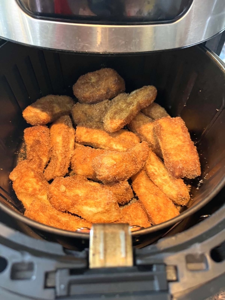 air fryer opened to show cooked churros