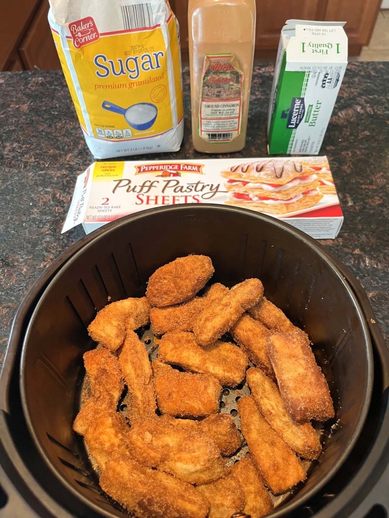 air fryer basket of churros next to puff pastry, butter, cinnamon, and sugar