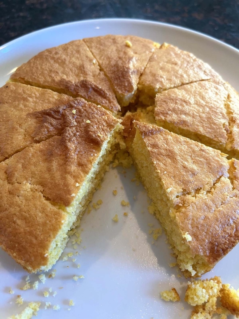 Air Fryer Cornbread on a plate with a slice cut out