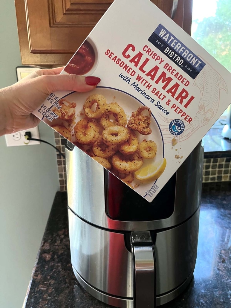 package of frozen breaded calamari in front of an air fryer