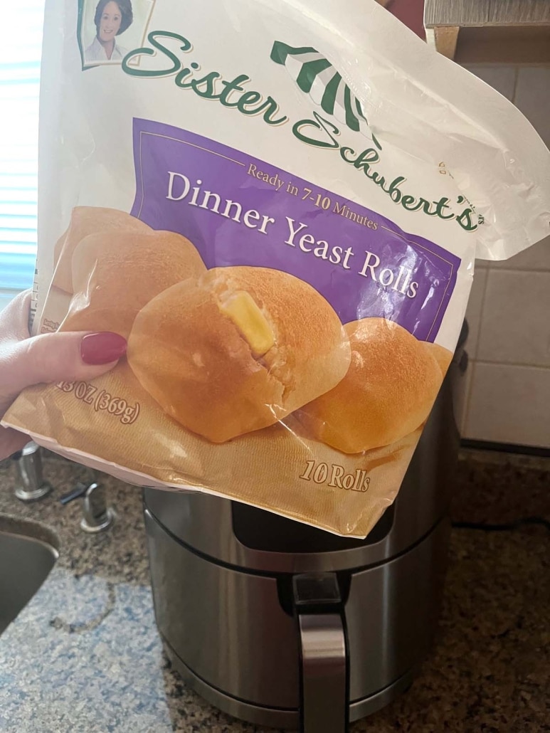 package of frozen dinner rolls in front of an air fryer