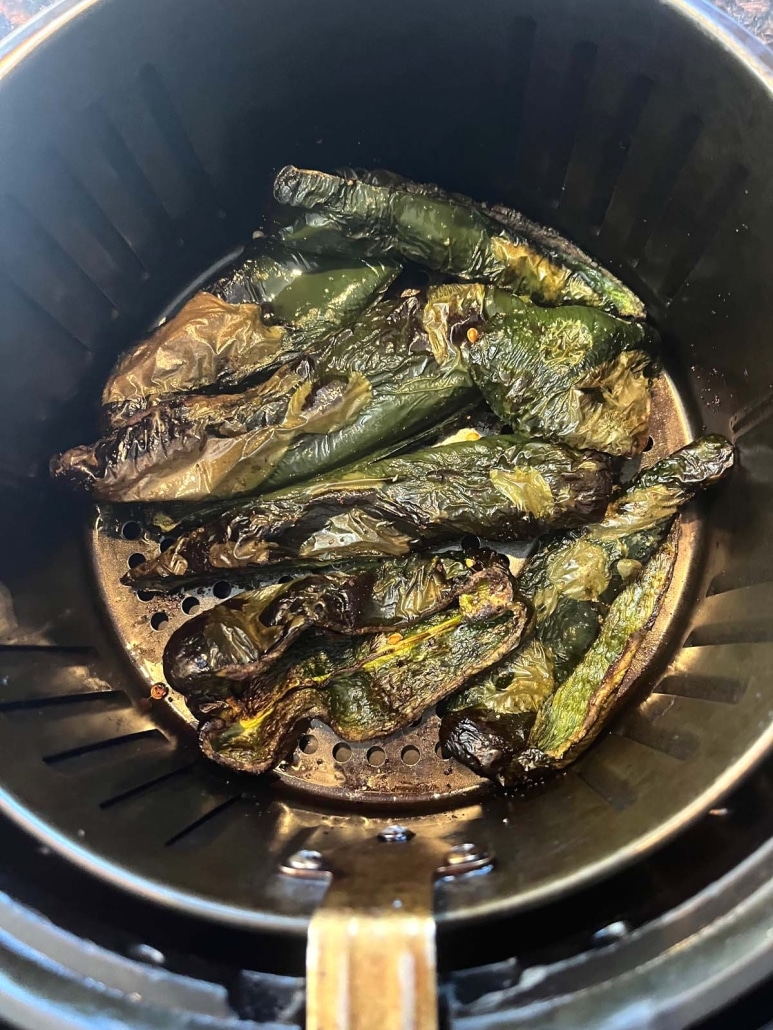 seasoned and roasted peppers in an air fryer basket