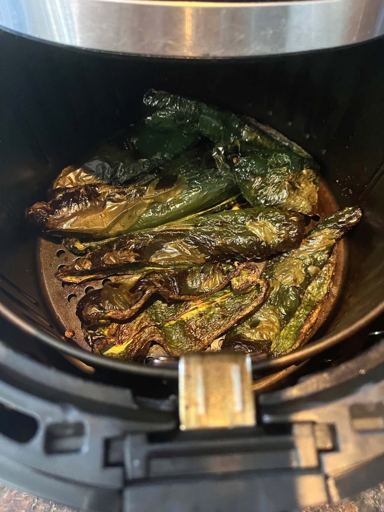 air fryer opened to show poblano peppers roasting inside