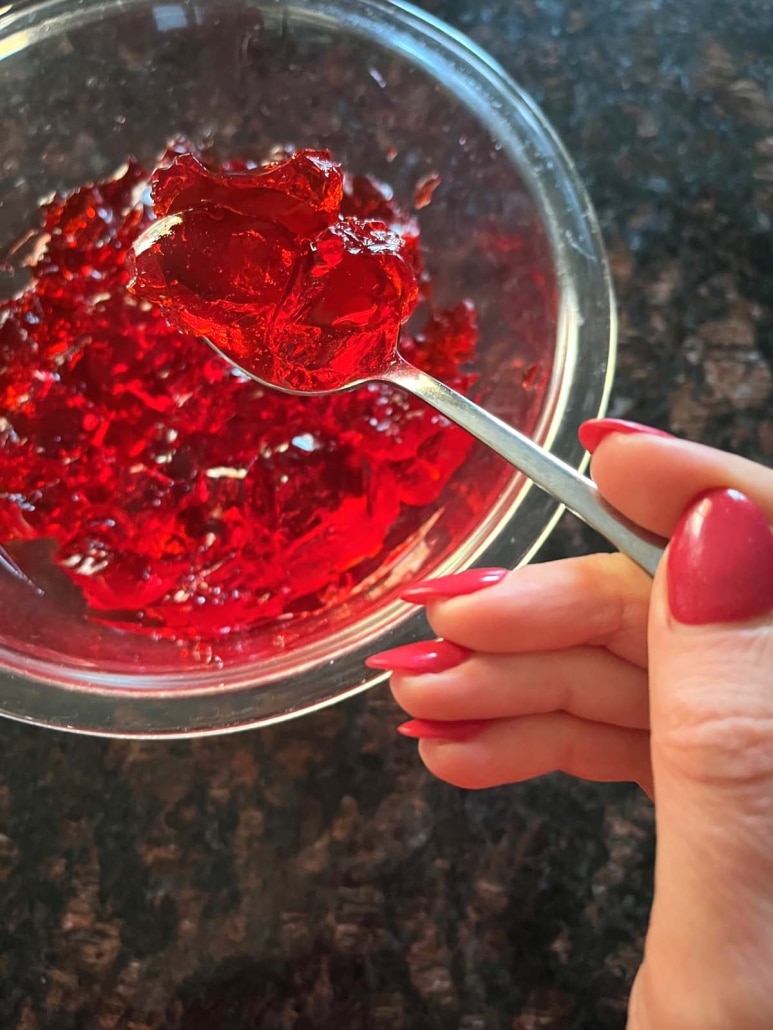 hand holding a spoon with Jello