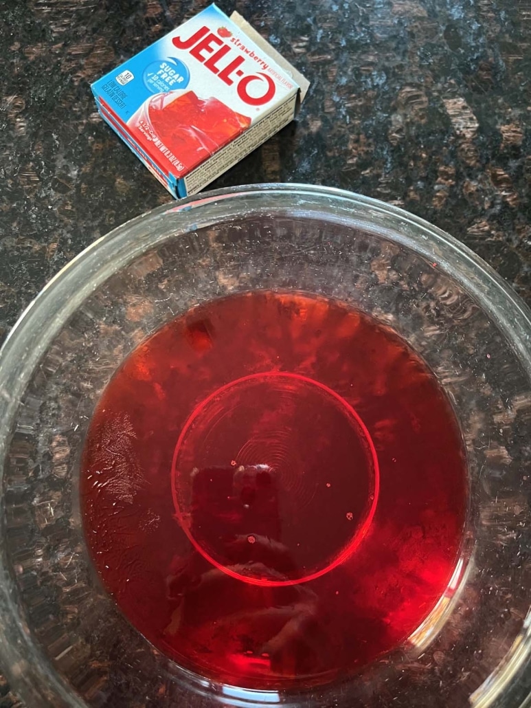 box of Jello mix next to a bowl of Jello snack