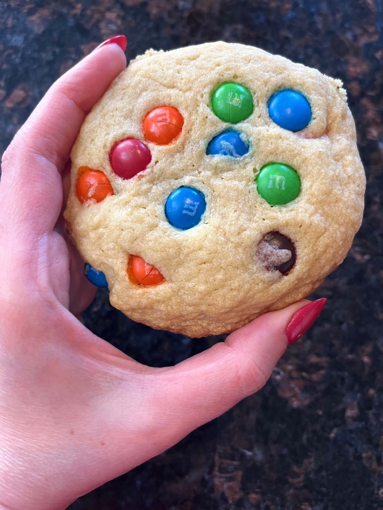 hand holding an M&M Cookie