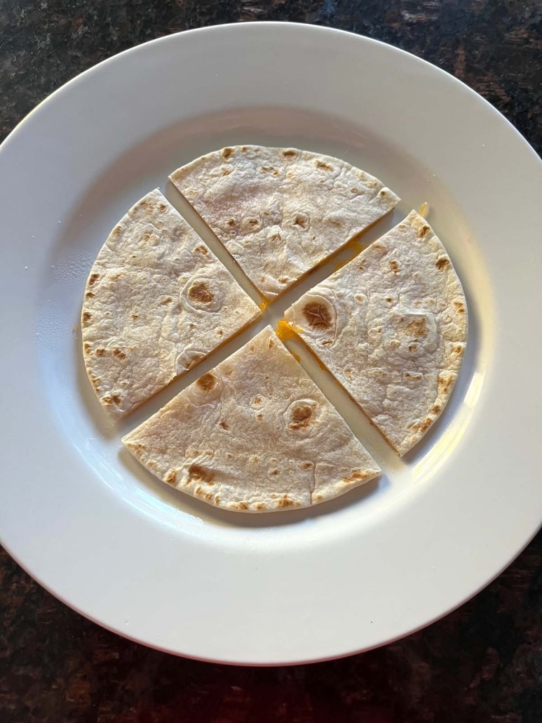 plate with simple cheese quesadilla cut into quarters