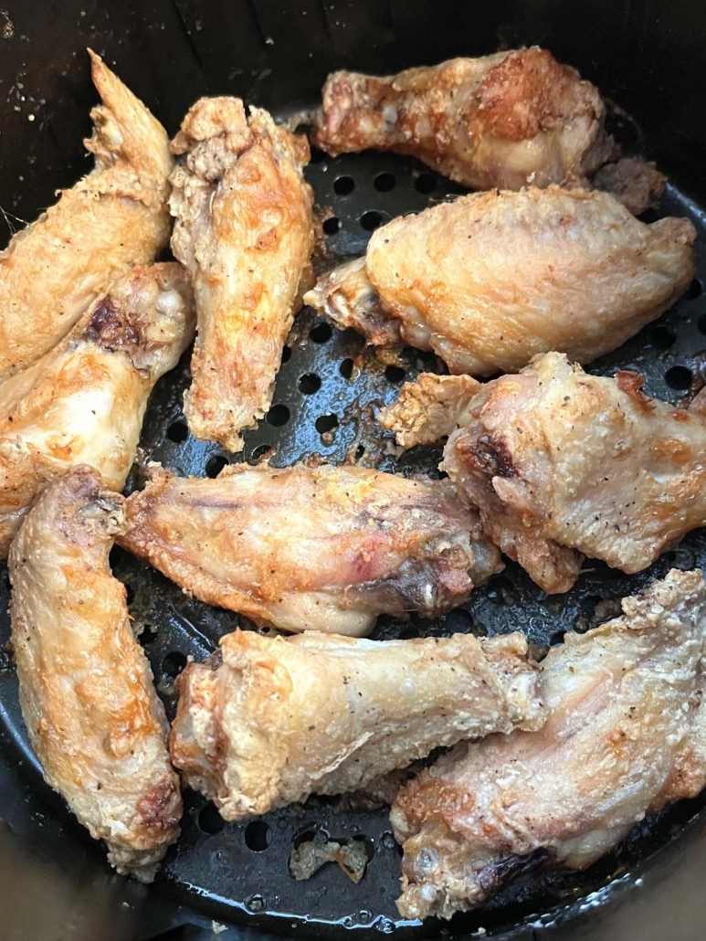 seasoned, golden brown chicken wings in air fryer