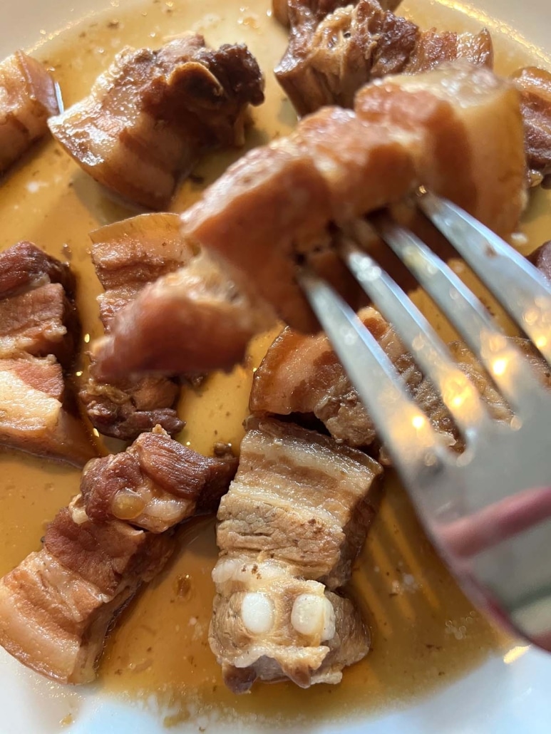 fork holding piece of Instant Pot Braised Pork Belly