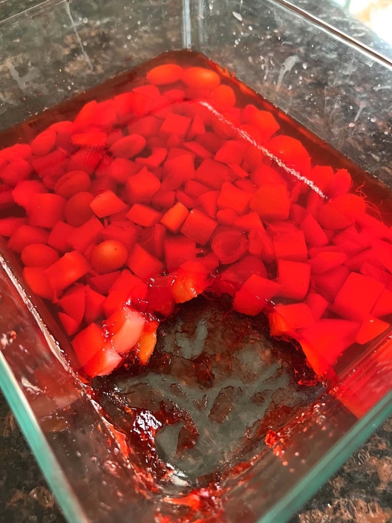 pan of Jello With Fruit Cocktail with scoop taken out