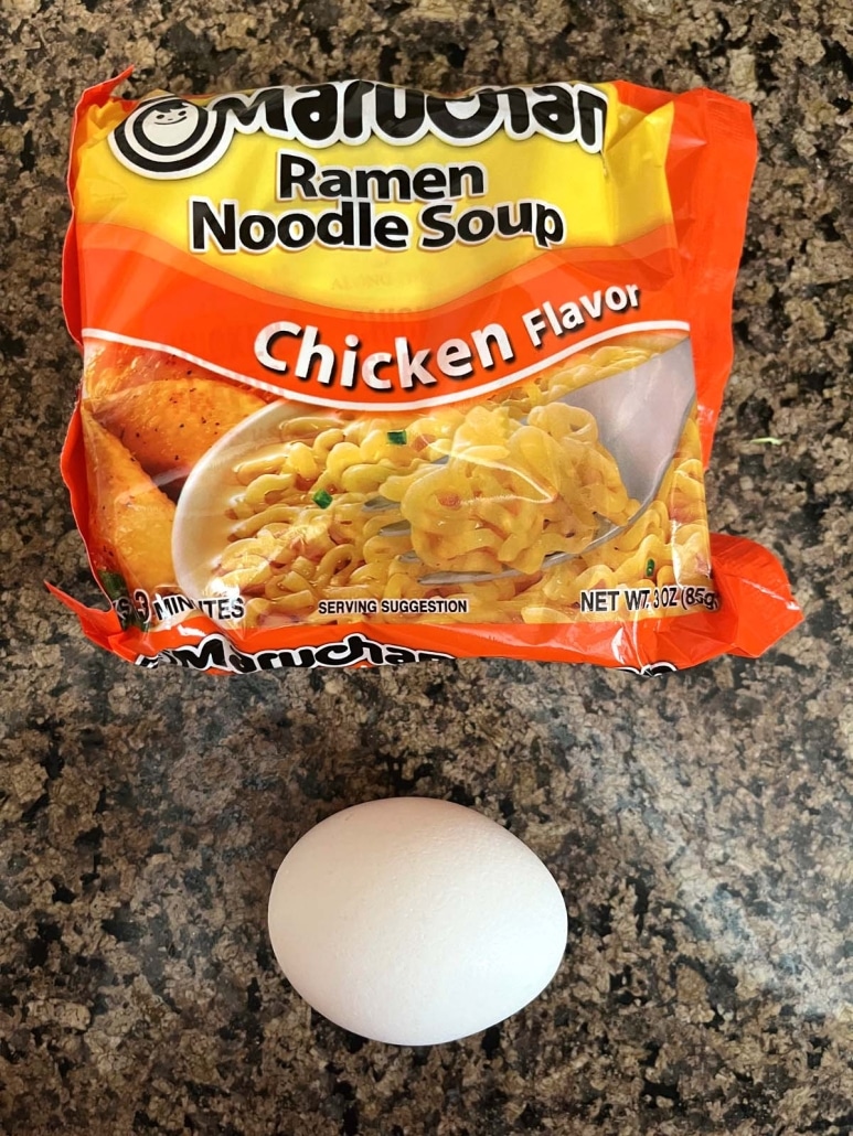 a packet of dried ramen noodles and an egg