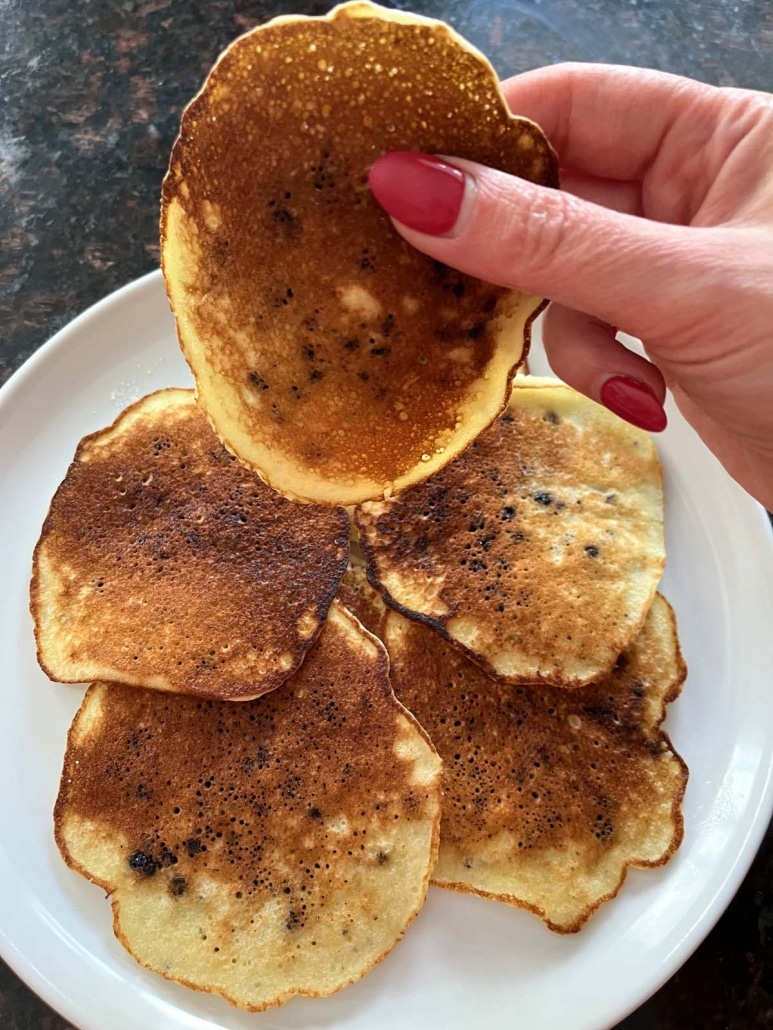 hand holding pancake made with blueberry muffin mix