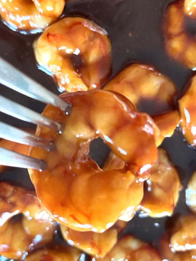 fork holding a teriyaki shrimp