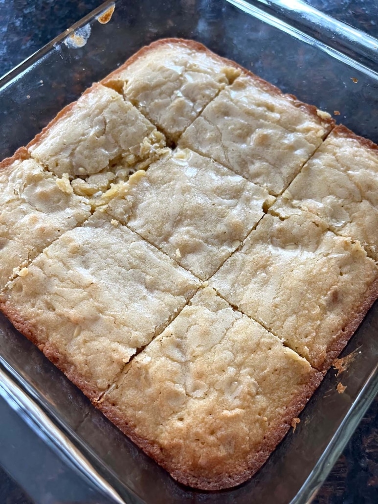 pan of easy dessert Vanilla Brownies With White Chocolate Chips, cut into pieces