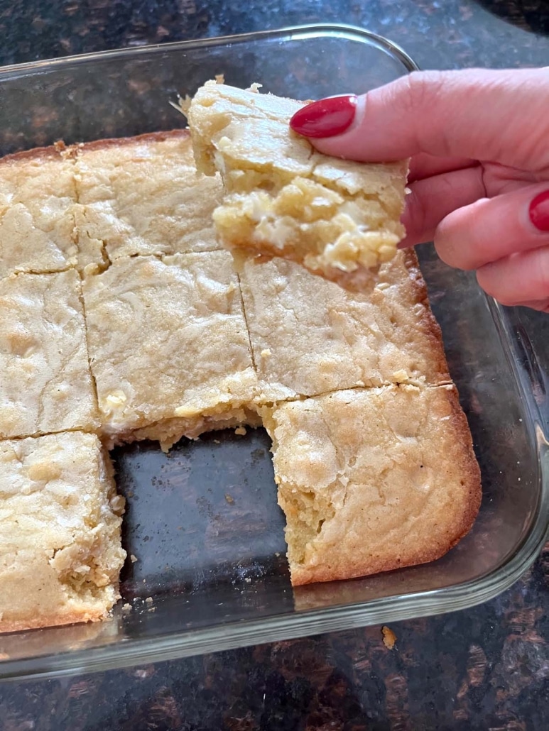 hand holding Vanilla Brownie With White Chocolate Chips