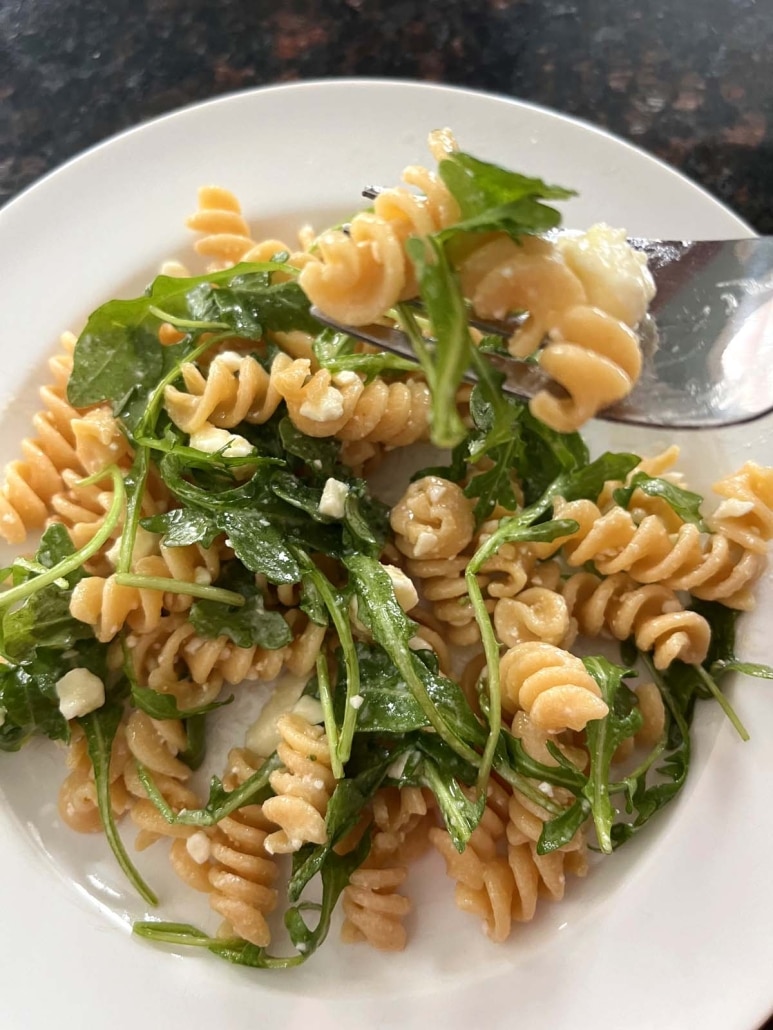 fork scooping up bite of easy side salad Arugula Pasta Salad