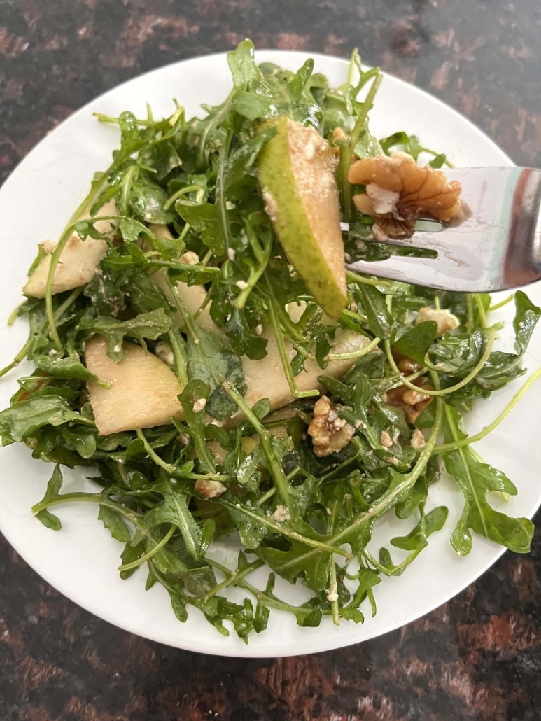 forkful of Arugula Pear And Goat Cheese Salad