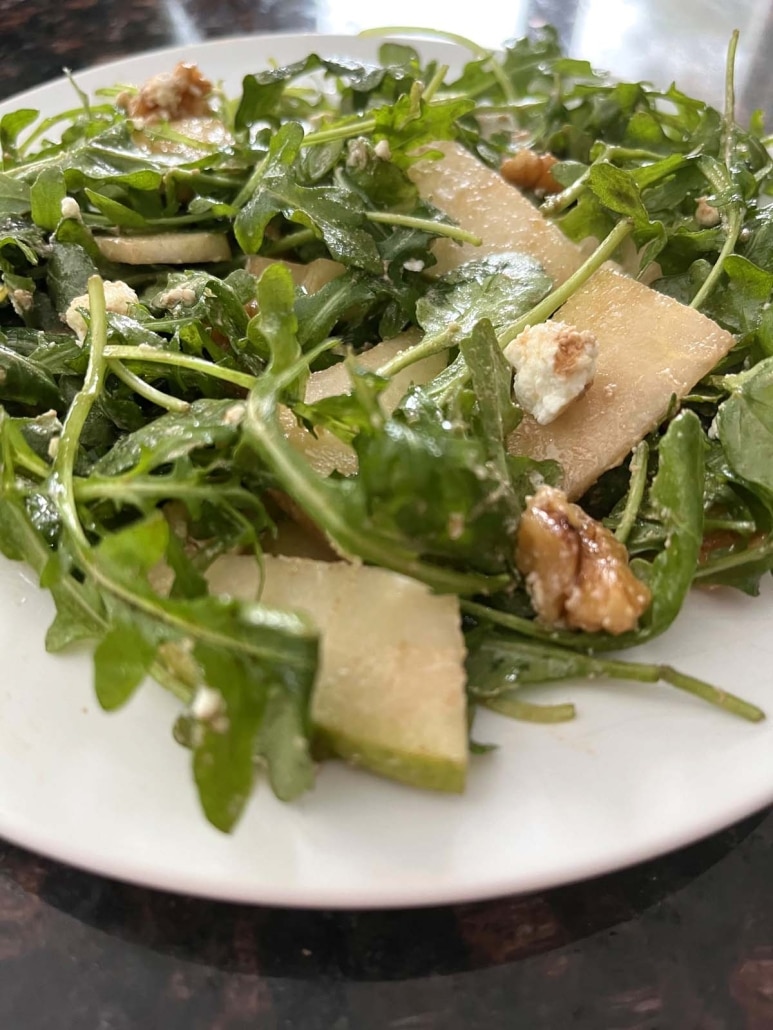 slices of pear on arugula salad