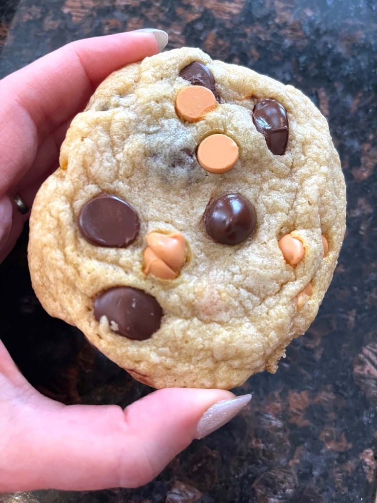 hand holding delicious treat or snack Caramel Chocolate Chip Cookie