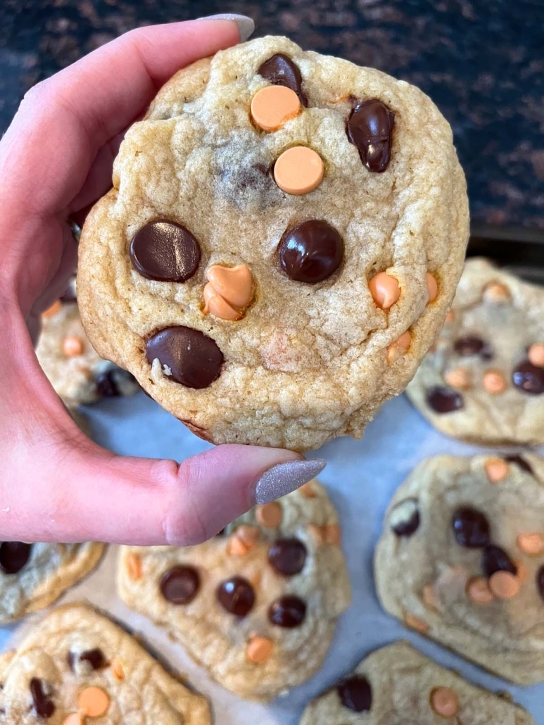 hand holding freshly baked Caramel Chocolate Chip Cookie