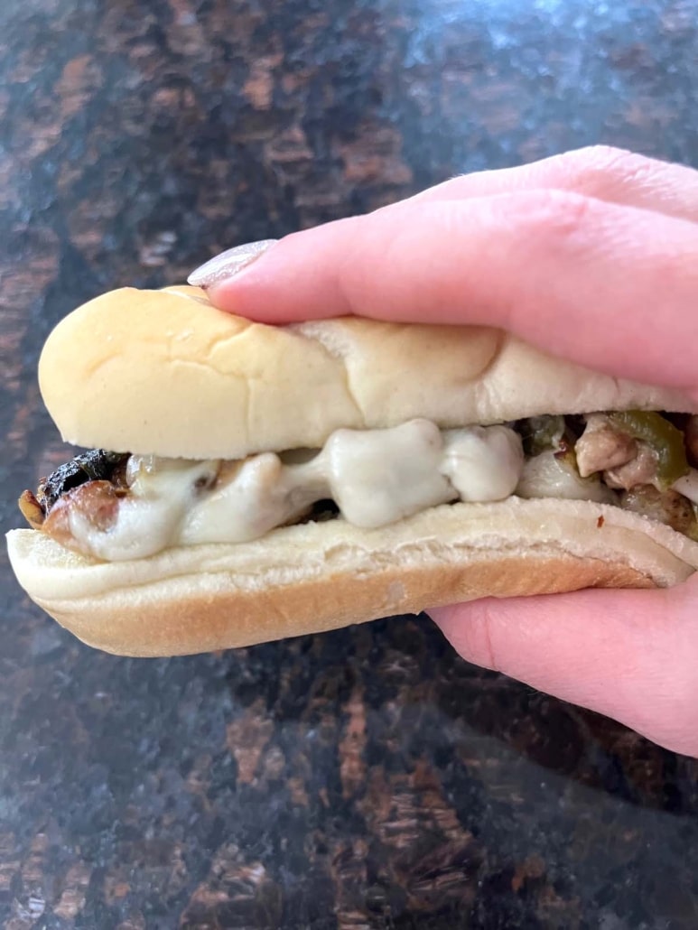 hand holding Chicken Philly Cheesesteak