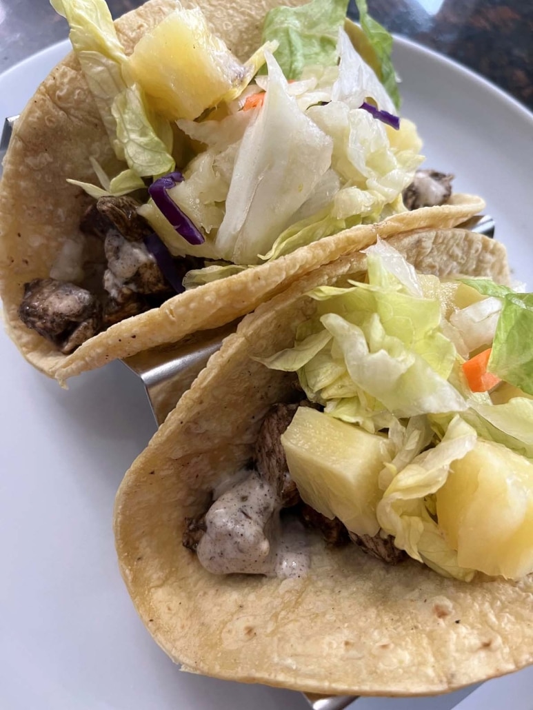 freshly topped Jerk Chicken Tacos on a plate