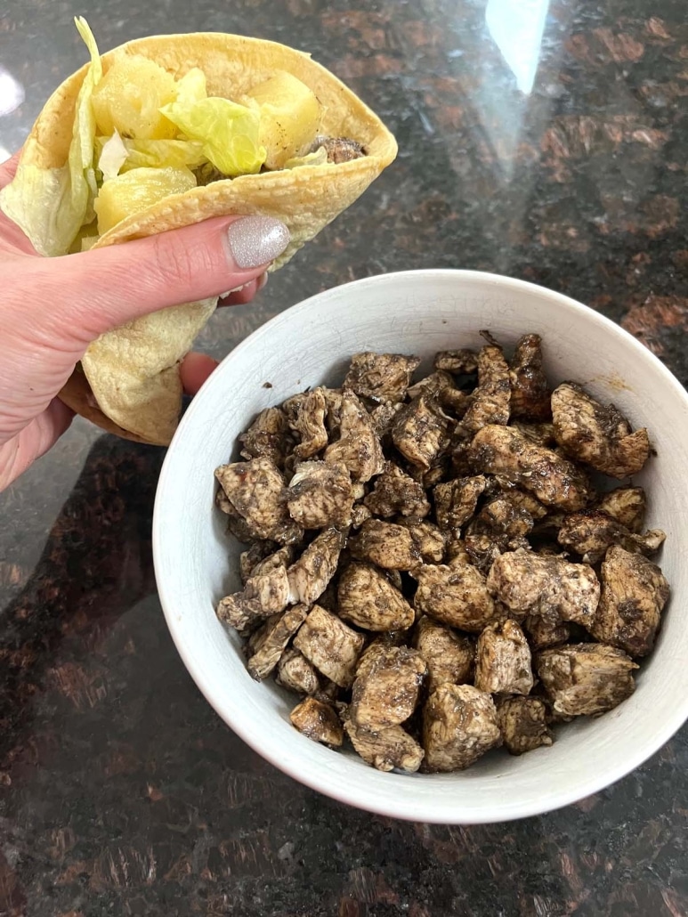 Jerk Chicken Taco next to a bowl of jerk chicken crumbles