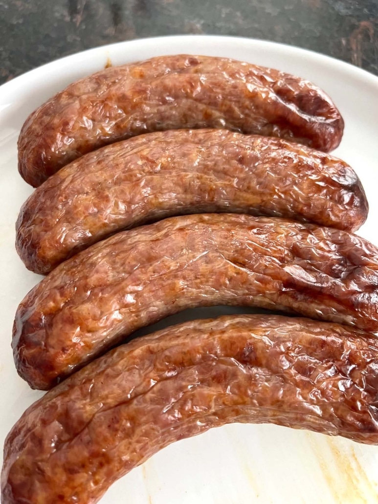 hot and juicy oven baked brats on a plate