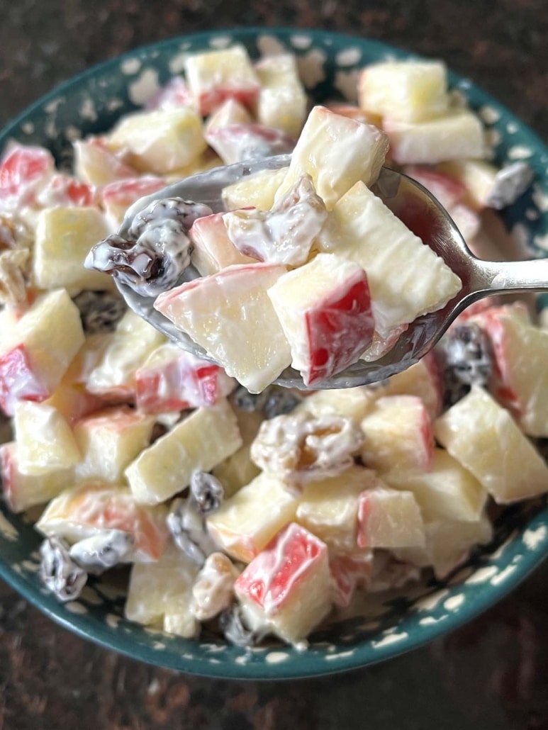 spoon scooping a bite of Apple Raisin Salad