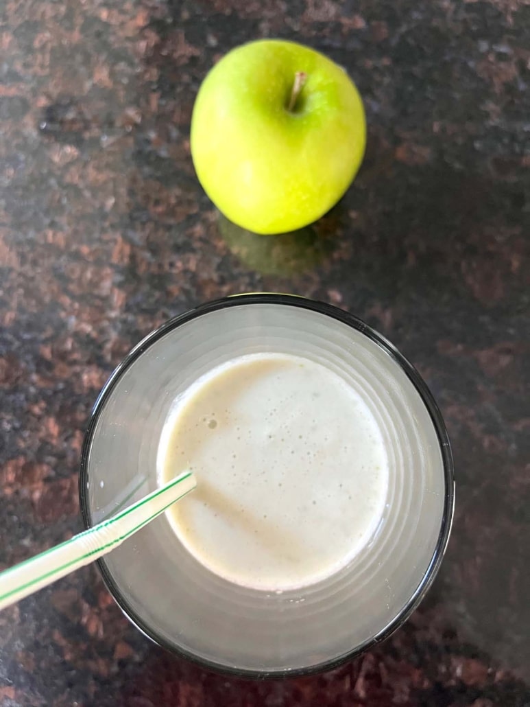 healthy Apple Cinnamon Smoothie next to a green apple