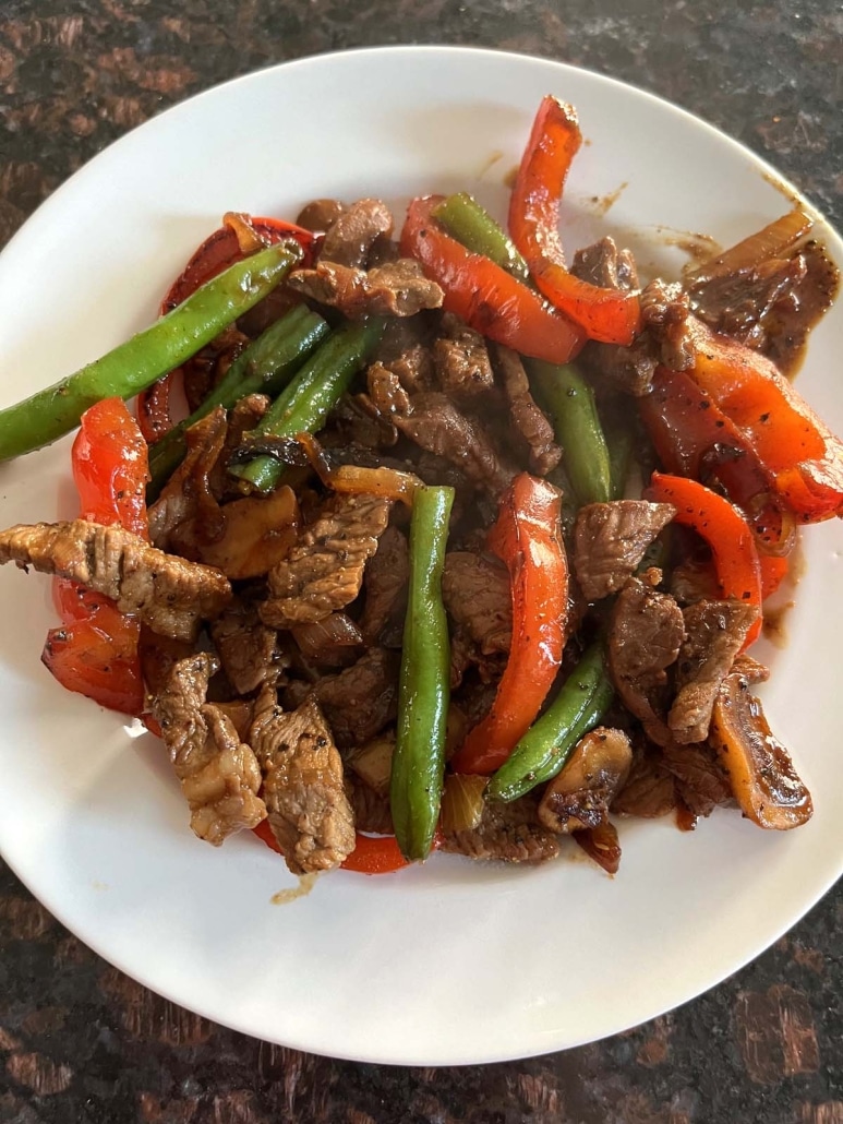 plate of black pepper angus steak and vegetables