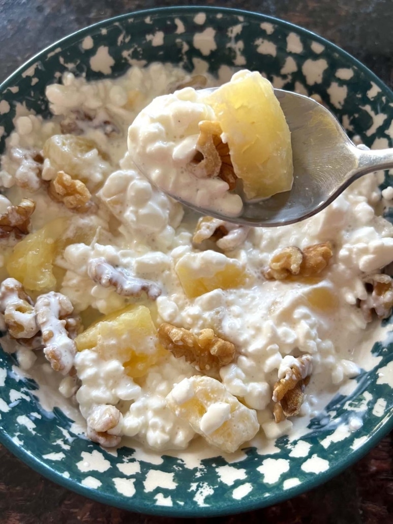spoon with a bite of healthy snack Cottage Cheese And Pineapple