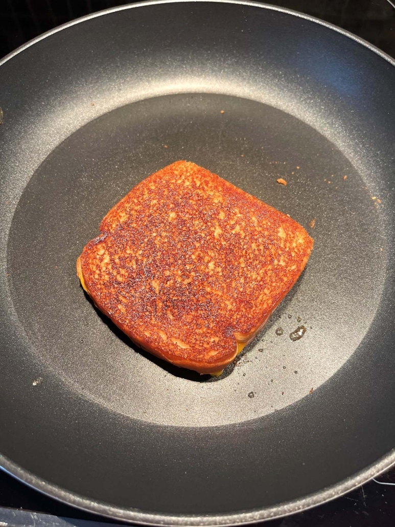 nicely brown Grilled Turkey And Cheese Sandwich in a hot skillet