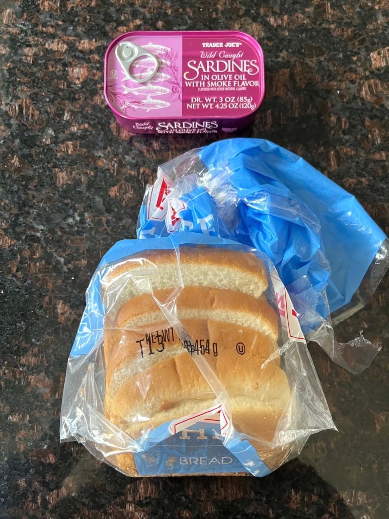 loaf of bread next to a tin of sardines