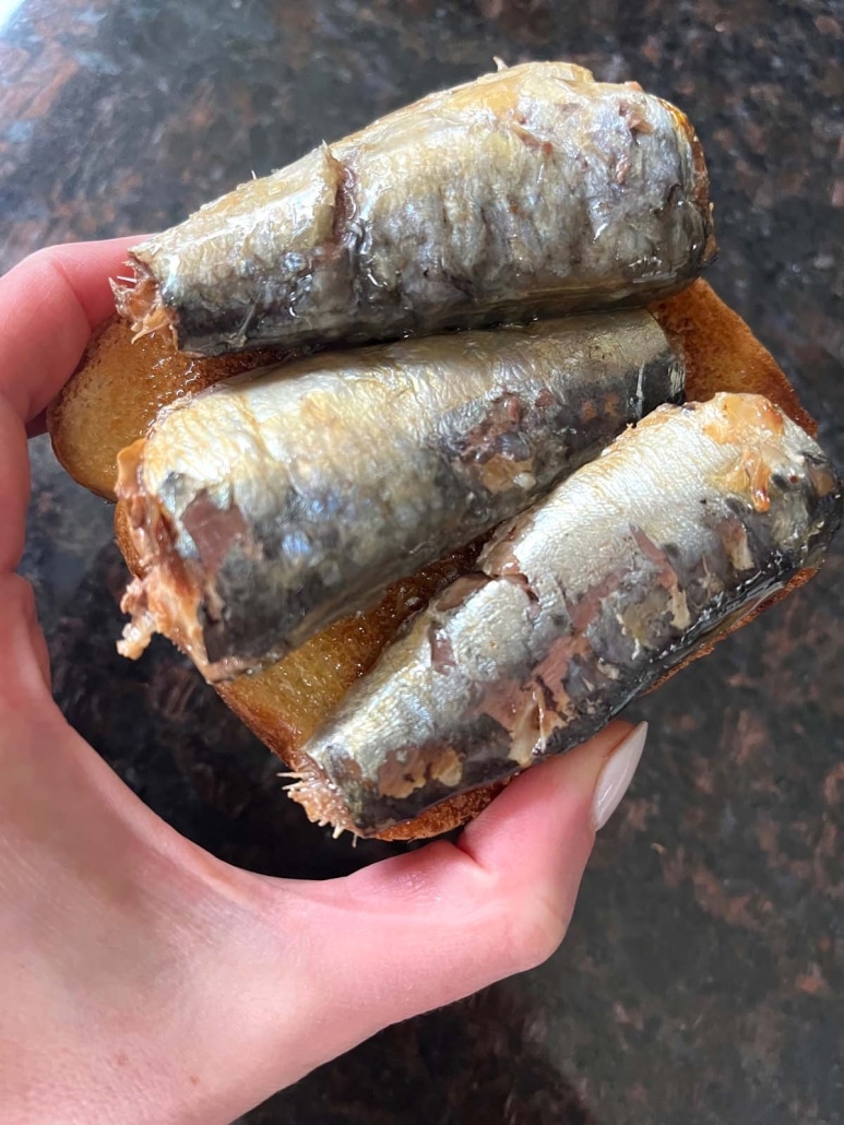 hand holding quick and tasty snack, Sardine Toast