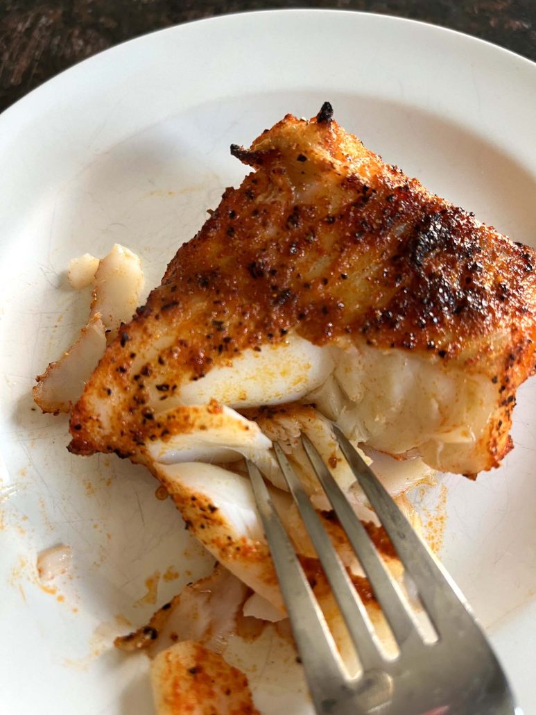 fork grabbing a bite of broiled cod