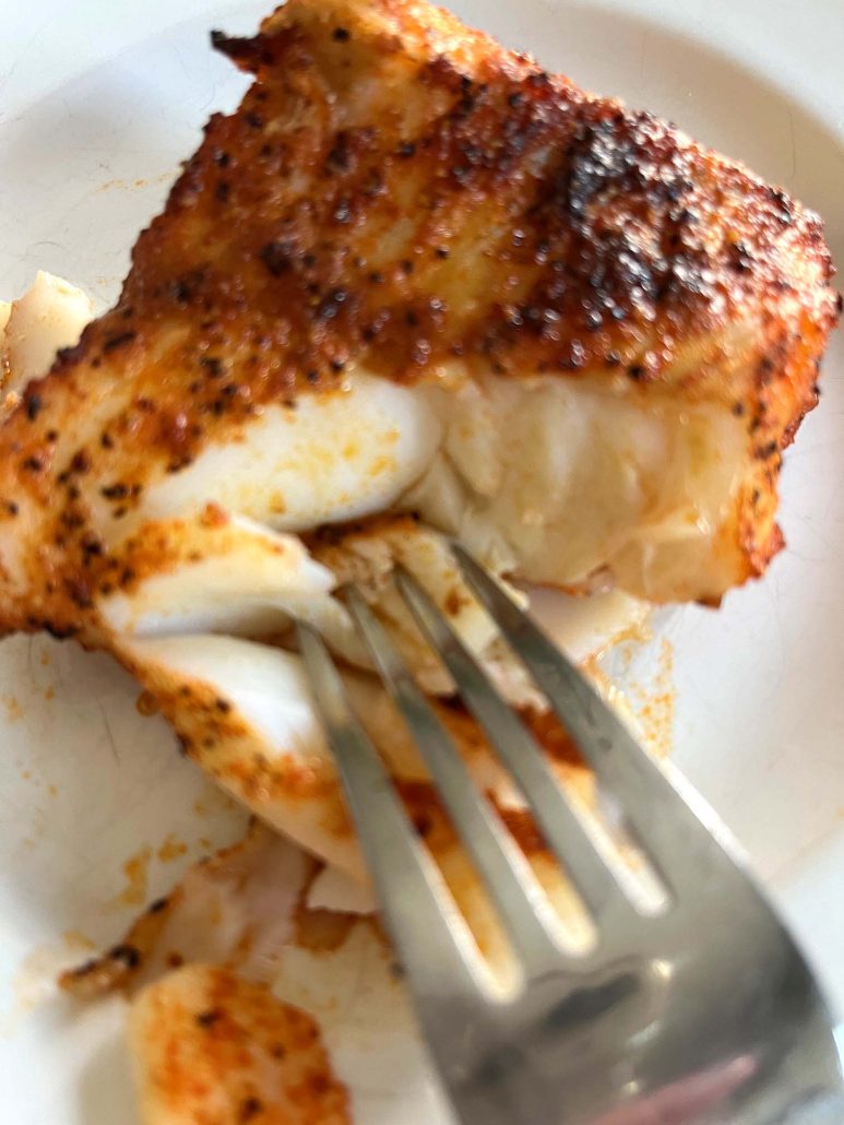 flaking broiled cod with a fork