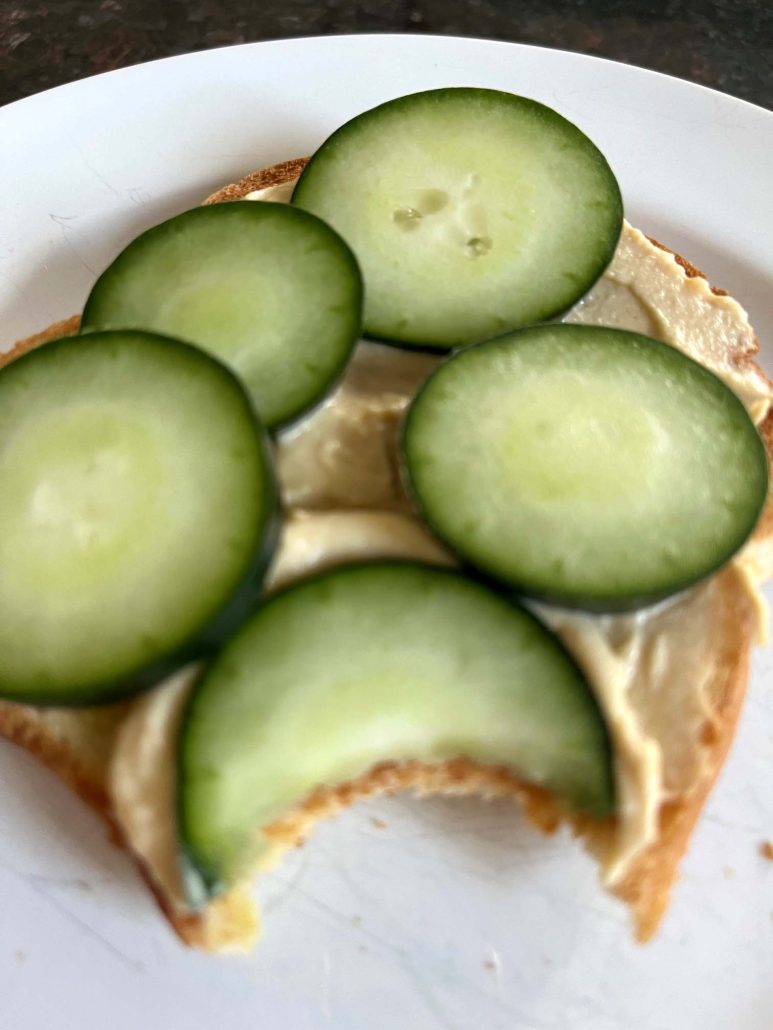 Hummus Toast with a bite taken out of it