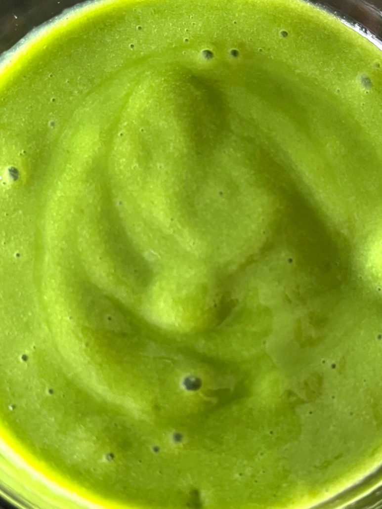 mango, spinach, and milk blended into a smoothie