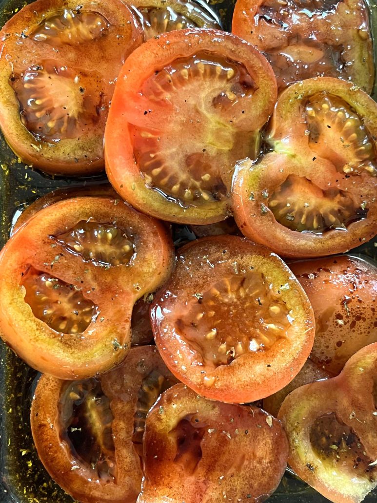 tomatoes marinating in oil, balsamic vinegar, and seasonings